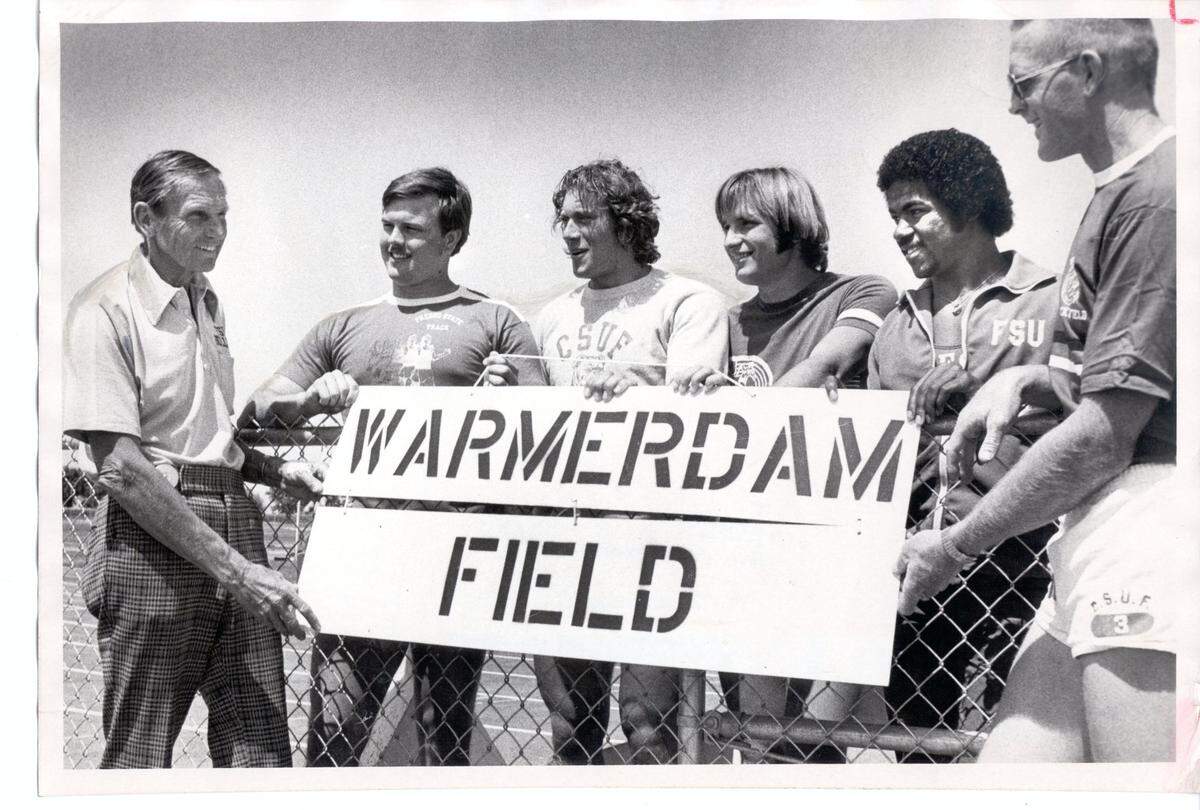 Dutch Warmerdam, left, shows off the new sign for Fresno State’s track along with NCAA championships-bound athletes, from left, Rick Fritzemier, Matt Mileham, Dennis Morley and Henry Ellard along with and assistant coach, Red Estes, who replaced Warmerdam.