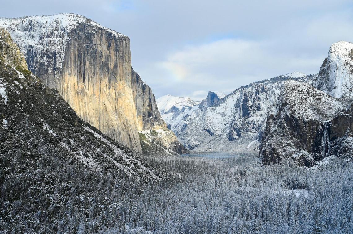 Snow covers the trees and cliffs in Yosemite Valley at Tunnel View in Yosemite on Wednesday, Dec. 15, 2021, following a snowstorm the day before.