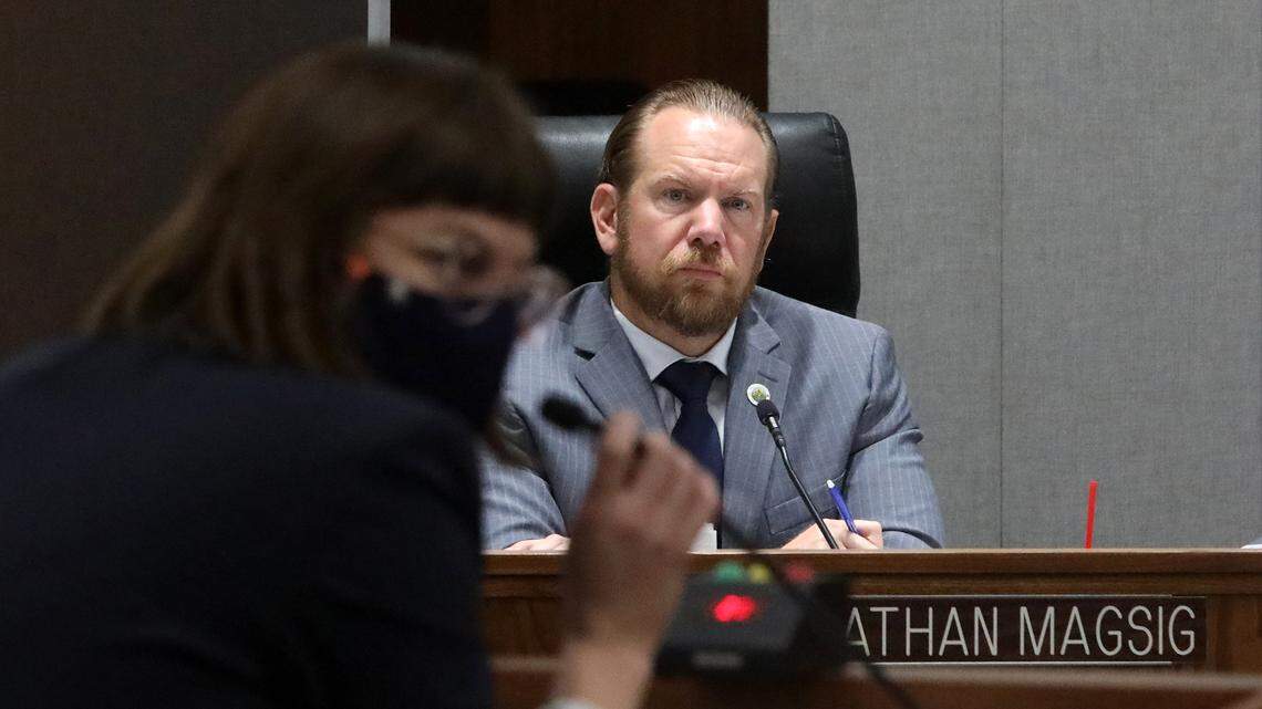 Fresno County Supervisor Nathan Magsig listens to a National Demographics Corporation staff member explain a proposed map.