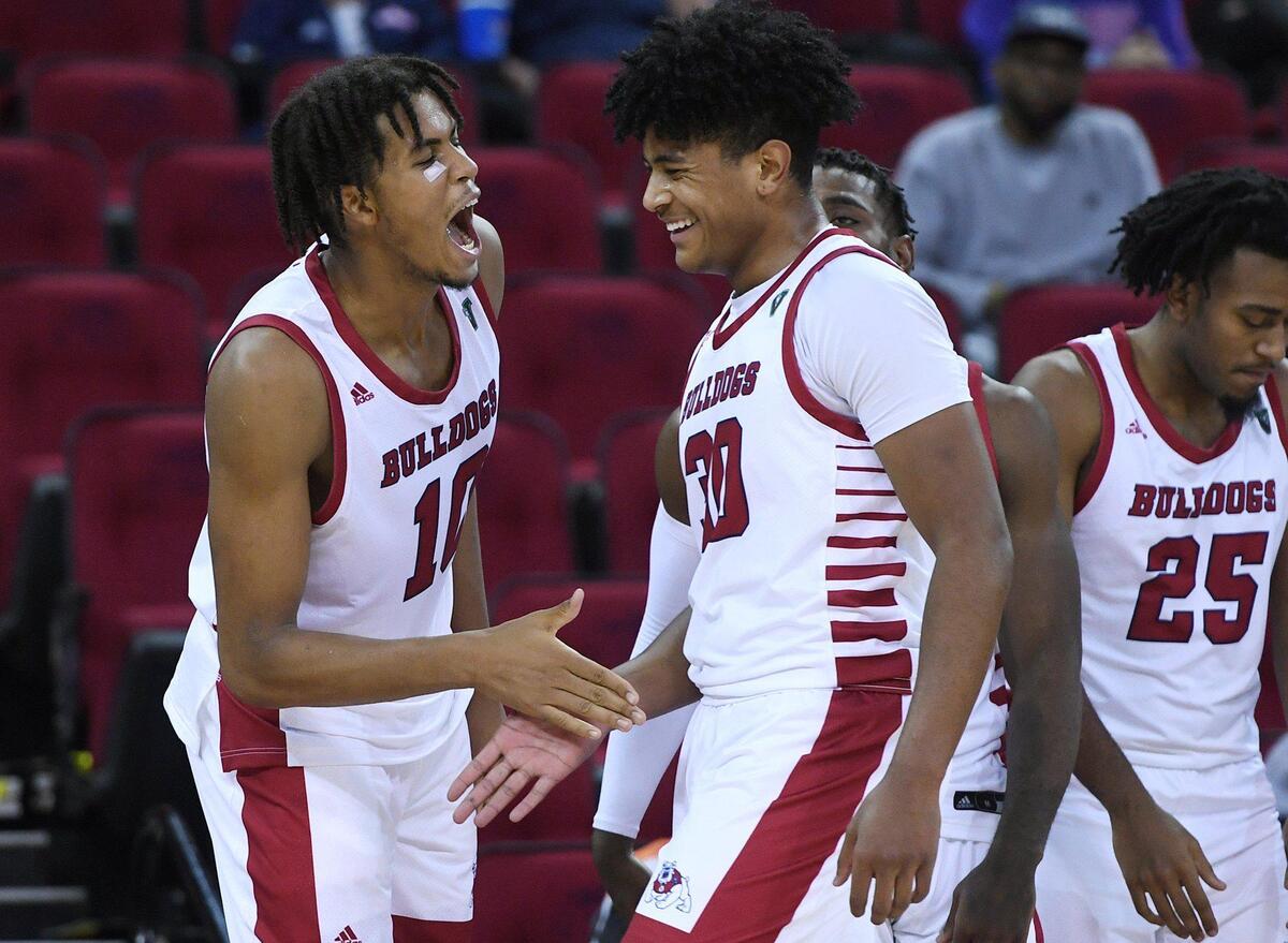 Fresno State junior forward Orlando Robinson, left, congratulates freshman foward Robert Vaihola’s game against Stanislaus State Wednesday, Nov. 3, 2021 in Fresno. Fresno State won 86-48.r