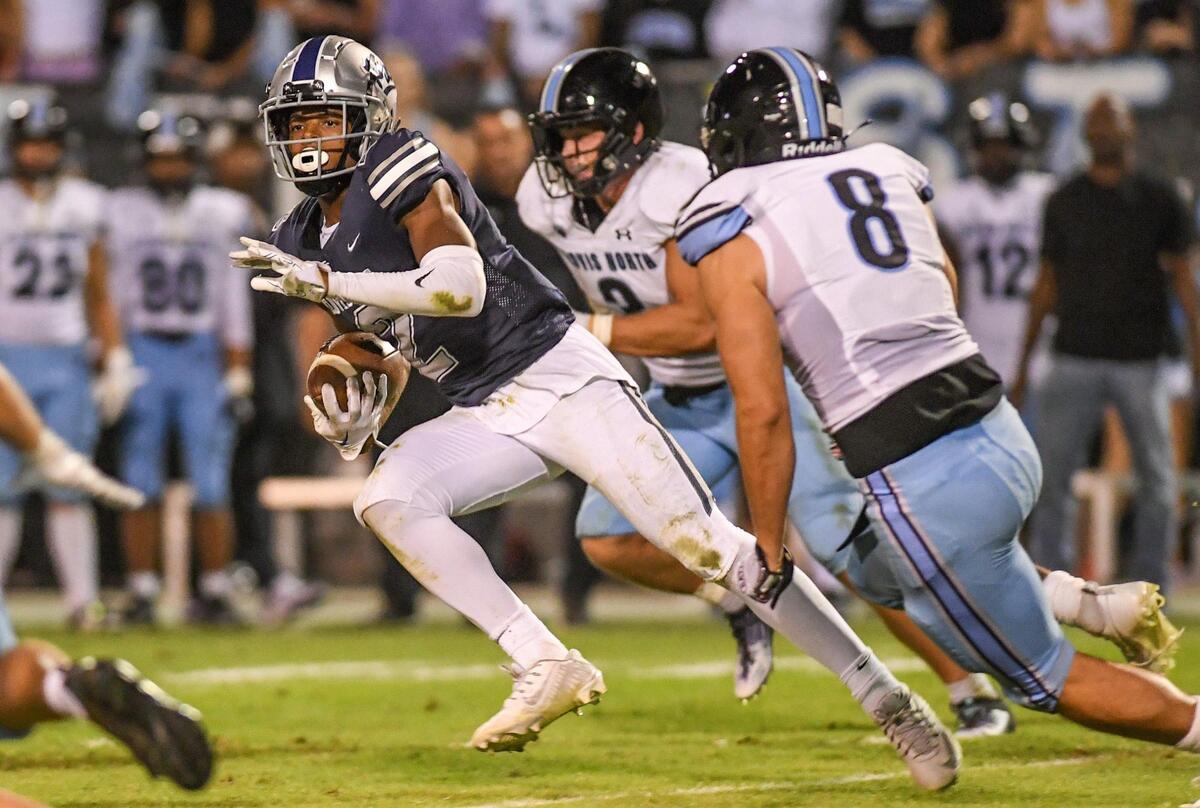 Clovis East’s Harold Duvall takes the ball into the secondary after a catch against Clovis North during their TRAC opener at Lamonica Stadium on Friday, Sept. 29, 2023.