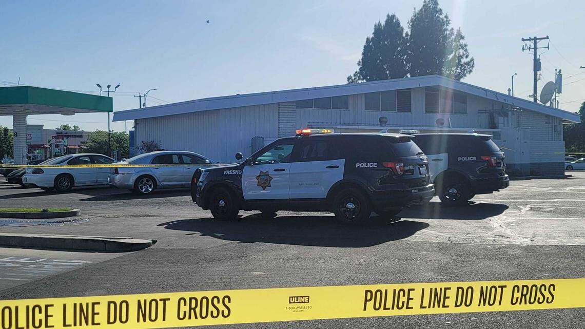 Fresno police secure a scene at the Sinclair station at First Street and Bullard Avenue on Monday, May 2, 2022.