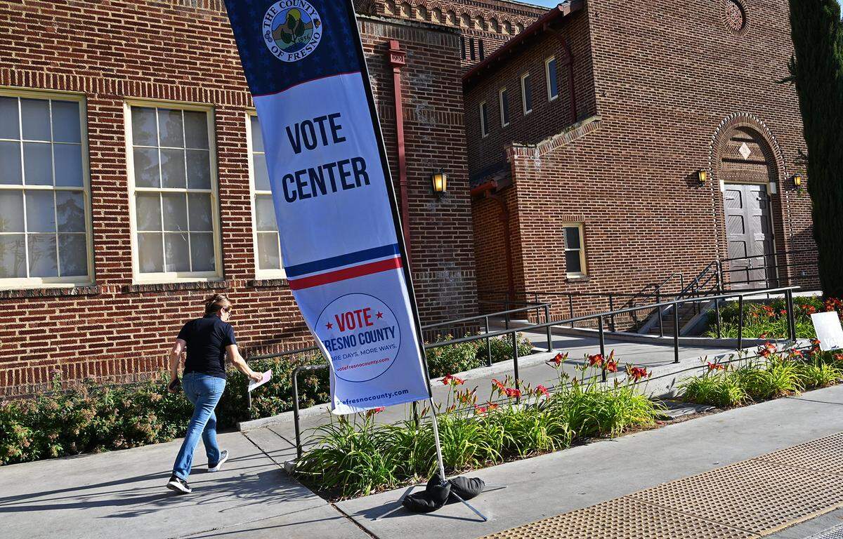 A voter hurries into the voting center at Fresno City College’s Old Administration Building on Tuesday, June 7, 2022 in Fresno.