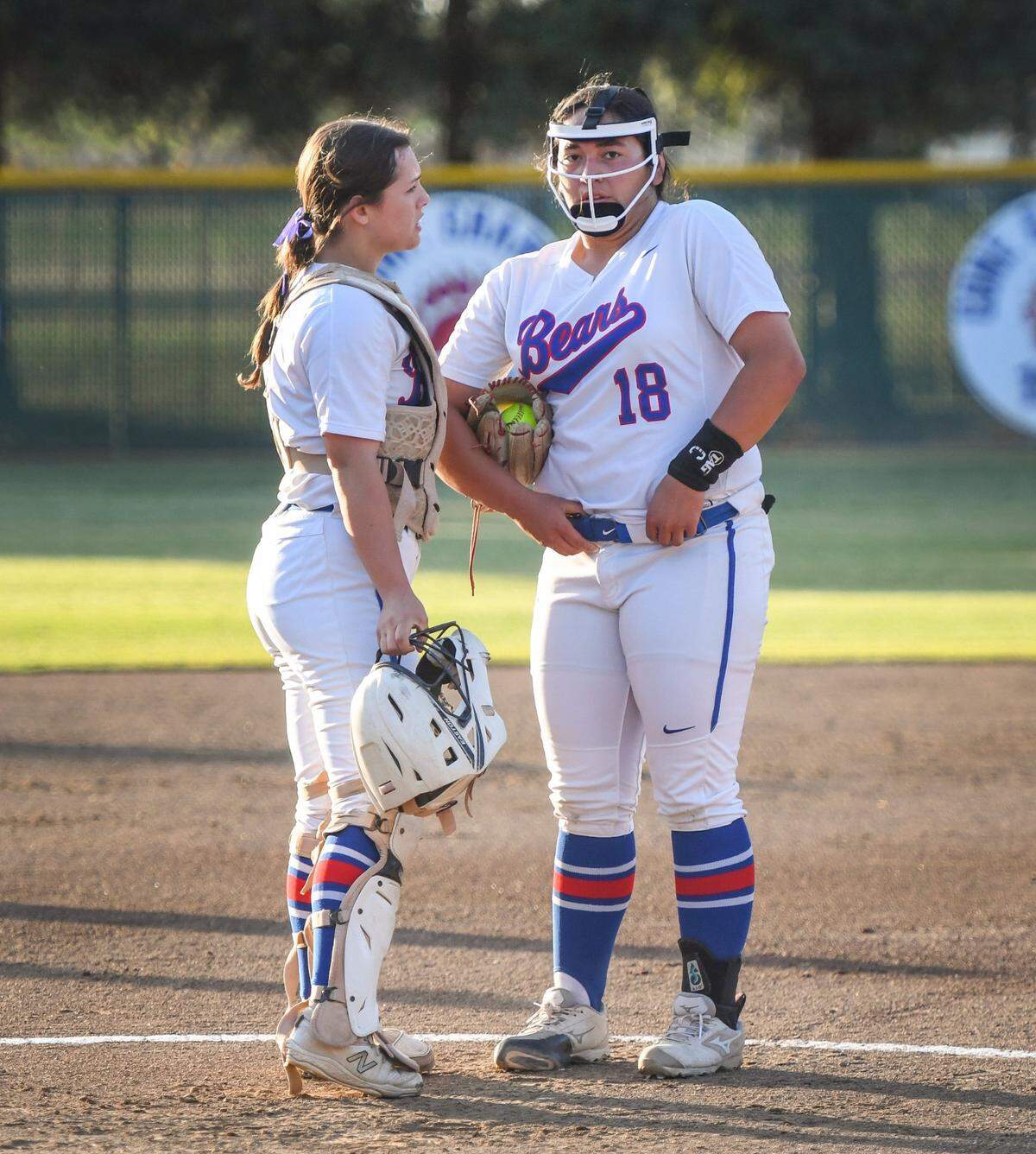 Buchanan catcher Autiana Buck, left, meets with pitcher Christal Lopez at the circle during their game against Clovis East at Buchanan on Friday, April 29, 2022.
