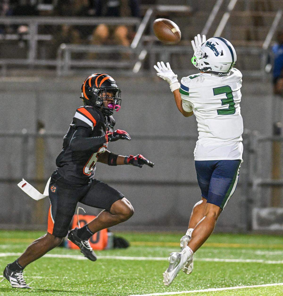 Clovis East's Marcellus Royal, right, catches a deep pass just short of the end zone while defended by Central East's Jontae Della during their playoff game at Deran Koligian Stadium in Fresno on Friday, Nov. 7, 2025.