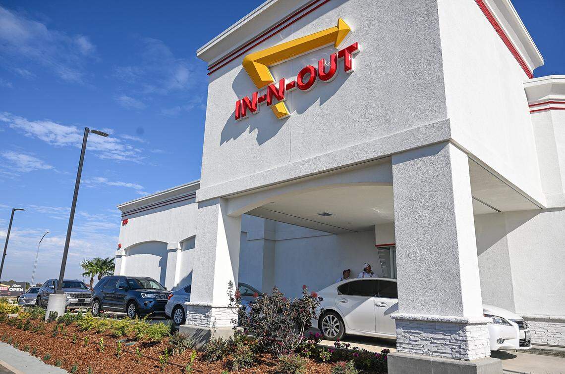 Cars line up in the drive-thru lanes of the new In-N-Out in the Fancher Creek shopping center on Clovis Avenue south of Belmont in southeast Fresno on its opening day, Wednesday, Nov. 12, 2025.