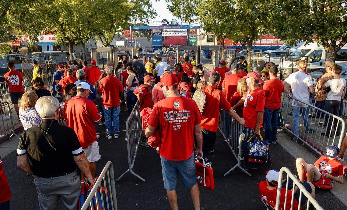 Bulldog fans wait in line before checking through security and entering Bulldog Stadium for the Fresno State football game against Toledo on Saturday, Sept. 29, 2018. 