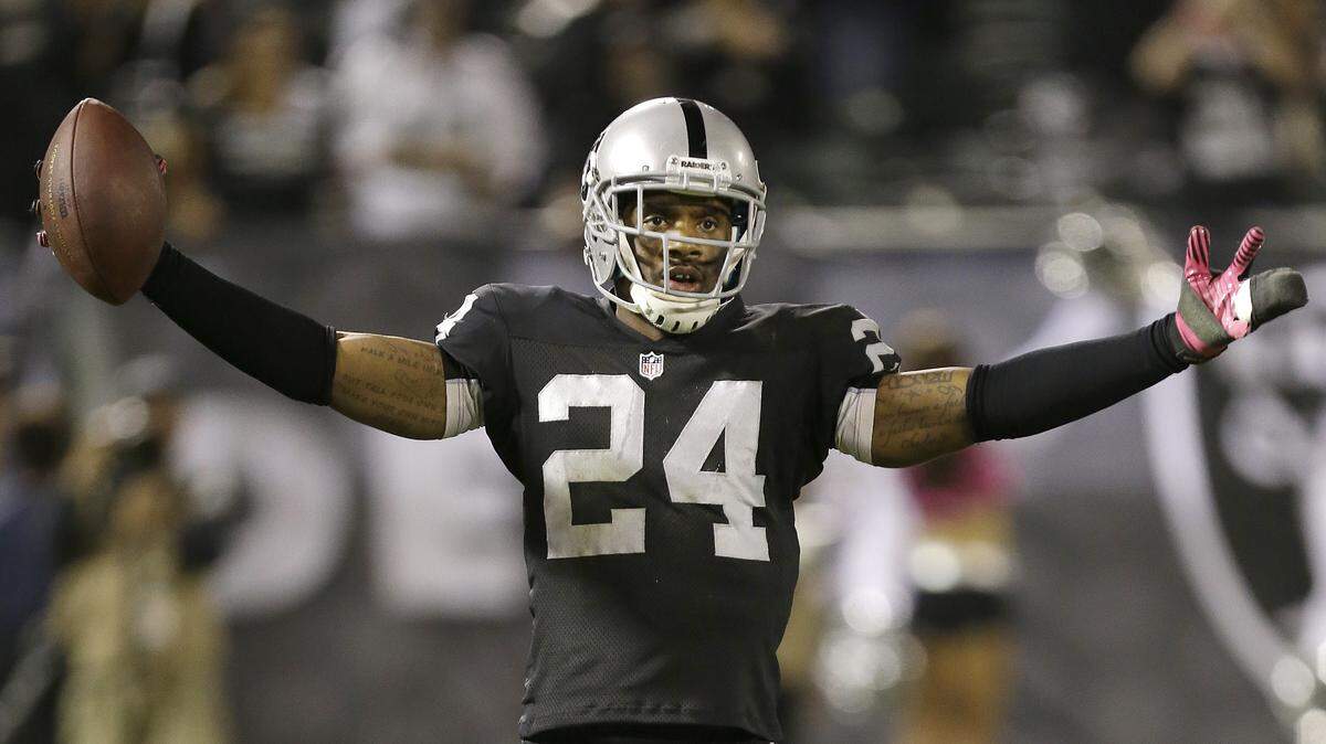 Oakland Raiders cornerback Charles Woodson (24) celebrates after intercepting San Diego Chargers quarterback Philip Rivers during the fourth quarter of an NFL football game in Oakland, Calif., Sunday, Oct. 6, 2013. The Raiders won 27-17. (AP Photo/Tony Avelar)