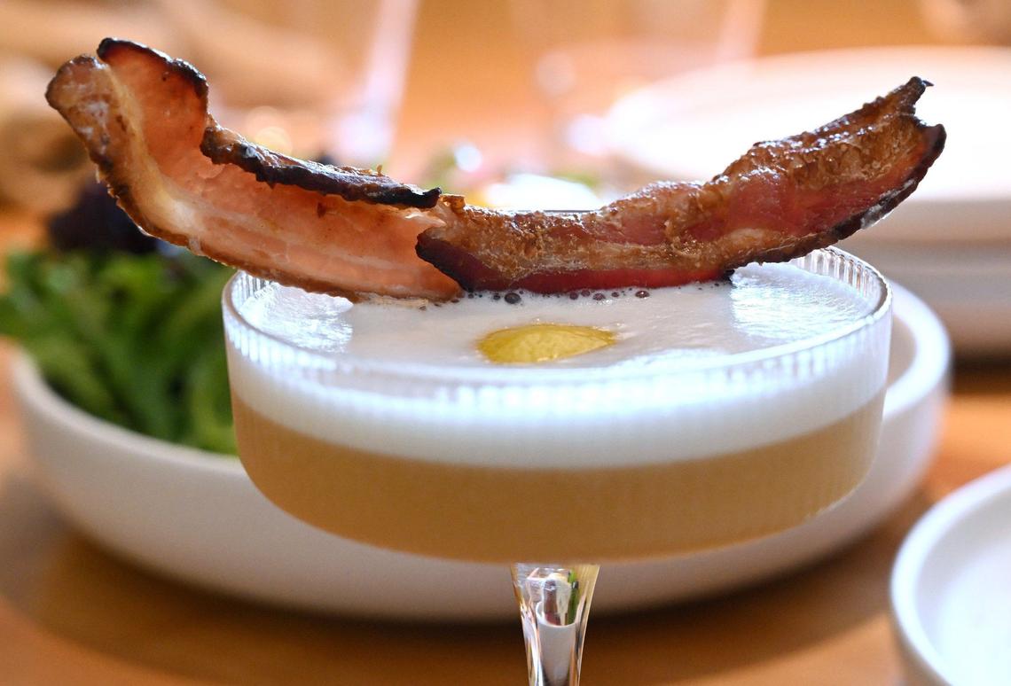 A slice of bacon tops Yolked Kitchen’s signature drink Everything But the Toast, which also includes bacon-washed whiskey, barrel-aged maple syrup, egg white and bacon. Photographed Thursday, July 11, 2024 in Clovis.