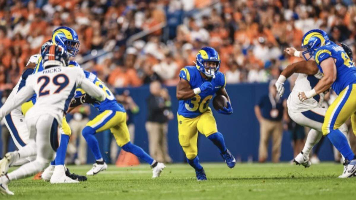 Ronnie Rivers carries the ball for the Los Angeles Rams in its NFL preseason game against the Denver Broncos.