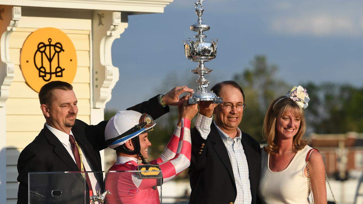 Rombauer trainer Michael McCarthy, left, jockey Flavien Prat, second from left, and horse owners John Fradkin and Diane Fradkin hold the trophy after winning the 145th Preakness Stakes horse race at Pimlico Race Course, Saturday, May 15, 2021, in Baltimore.