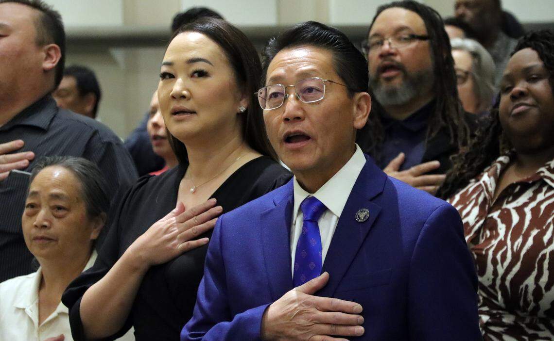Fresno City Councilmember Brandon Vang and his wife, May Lee, join in the Pledge of Allegiance at Fresno City Hall on April 10, 2025. He will serve a two-year term.