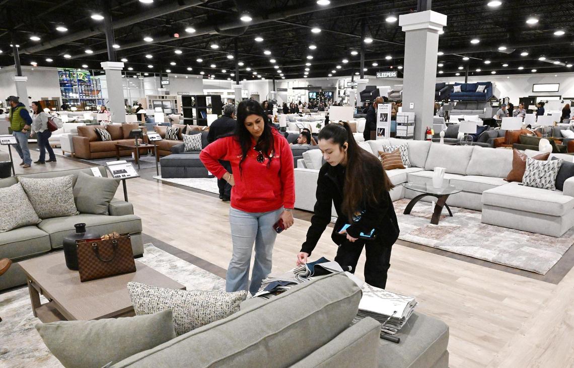 A Living Spaces employee, right, helps a customer during Friends & Family night Wednesday, Feb. 5, 2025 in Fresno. The expansive showroom includes a children’s play area and cafe serving family-friendly food, plus beer and wine for adults. The grand opening is 10 a.m. Friday, Feb. 7, 2025.