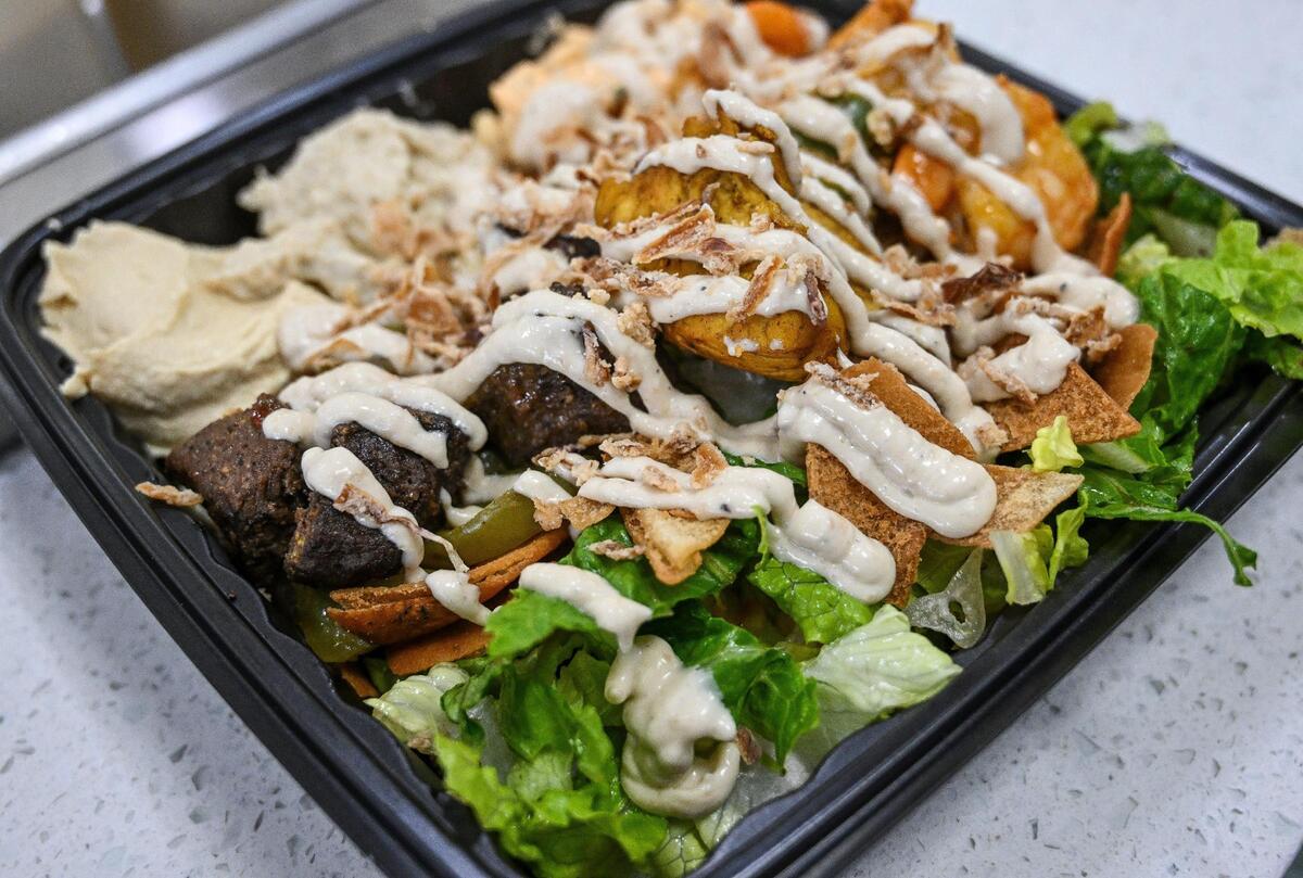 A custom plate made to order from Kabab Time features a choice of three proteins, sauces and toppings.