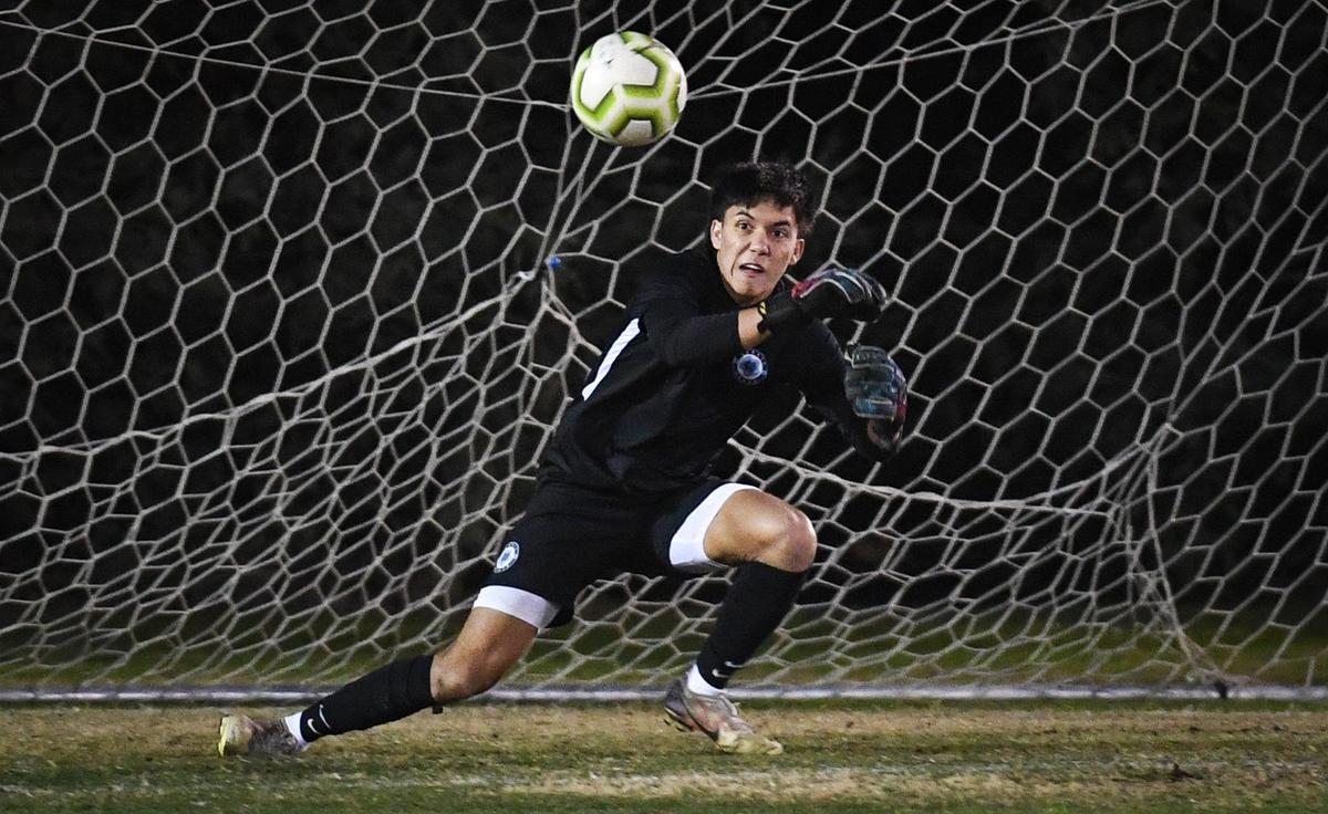 Clovis North goalkeeper Lucas Tabangcura prepares to stop a shot on the goal during their game against Clovis West at Tice Park in Fresno on Friday, Jan. 28, 2022.