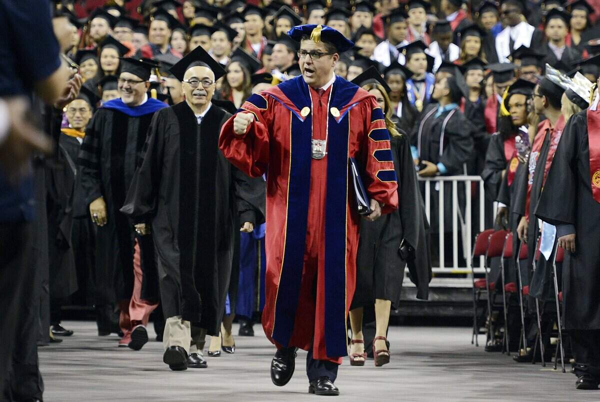Fresno State president Joseph Castro enters the floor of the Save Mart Center during the Fresno State commencement program, Saturday, May 21, 2016.