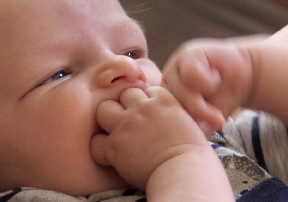Newborn Everett, 2 months old, looks up at his mother Sara Sherwood as she shares her experiences breastfeeding in an interview at home Friday, July 20, 2018 in Fresno.