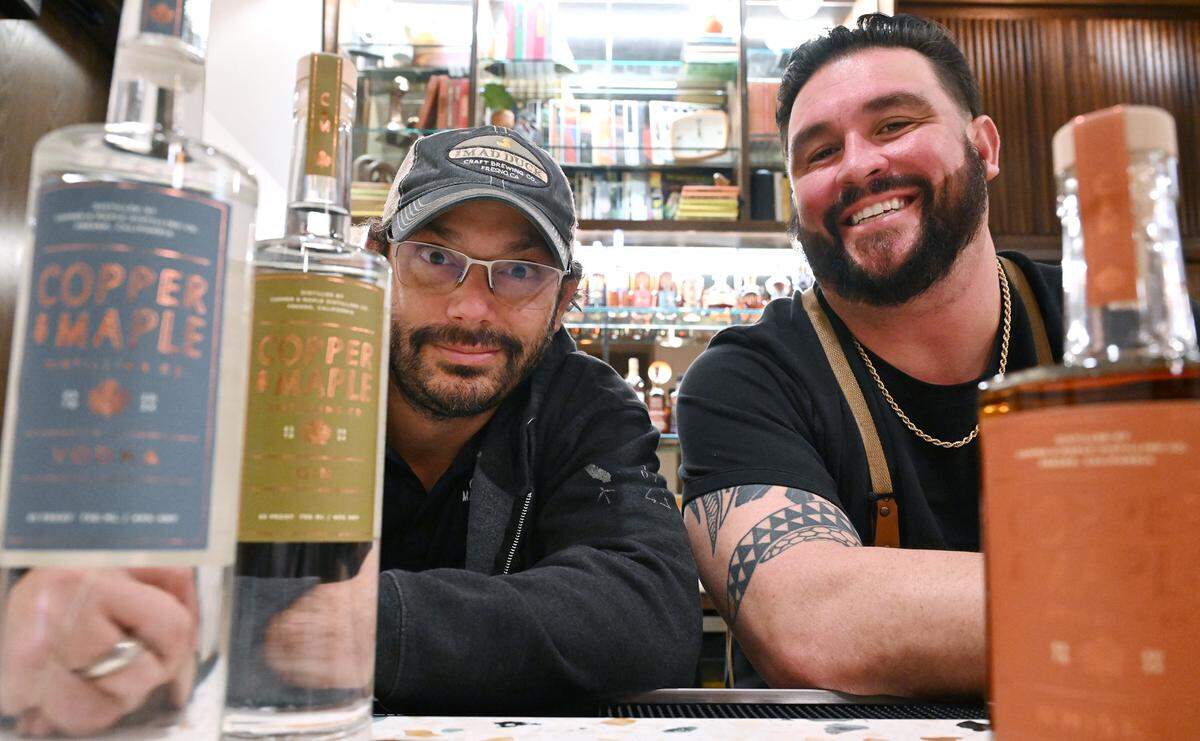 Alex Costa, distilling consultant with Maple & Copper Distilling Company, left has joined forces with The Golden Hour Cocktail Lounge general manager Dustin Llanes, right, to offer a blending of in-house distilled spirits, cocktail drinks and a lounge with throwback vibes for customers. Both are adjacent to Mad Duck Craft restaurant and Brewing on Copper Avenue. Photographed Wednesday, Feb. 4, 2026 in Fresno.
