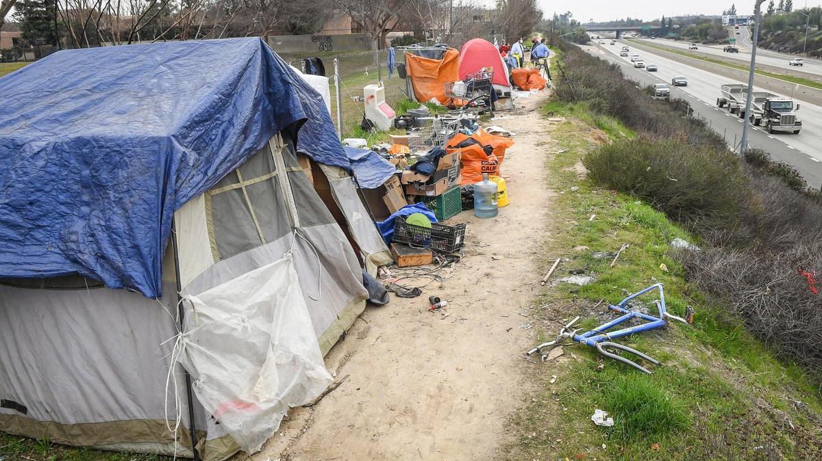 A homeless encampment sits along Highway 41 near Bullard Avenue in north Fresno in this February 2021 file photo. Homelessness is one symptom of poverty, but many low-income residents who live below the poverty line are not homeless. Almost 21% of Fresno County residents lived in poverty from 2016 through 2020, according to U.S. Census Bureau estimates released in March 2022.