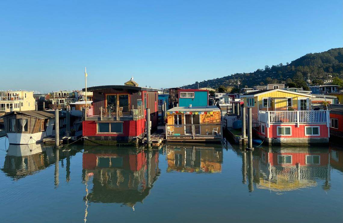 A group of houseboats sit moored to docks and pillars in Sausalito, California, in October 2022. The San Francisco Bay seaside surburb features one of the world’s largest communities of floating homes.