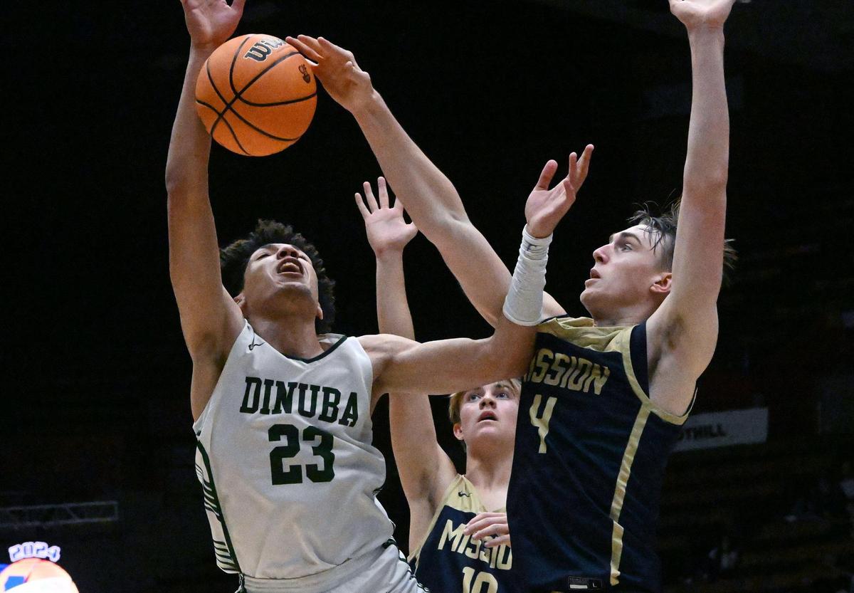Dinuba’s Brice Warley, left, and Mission Prep’s Luke Jacobson, right, in the Division II game Friday, Feb. 23, 2024 in Fresno..