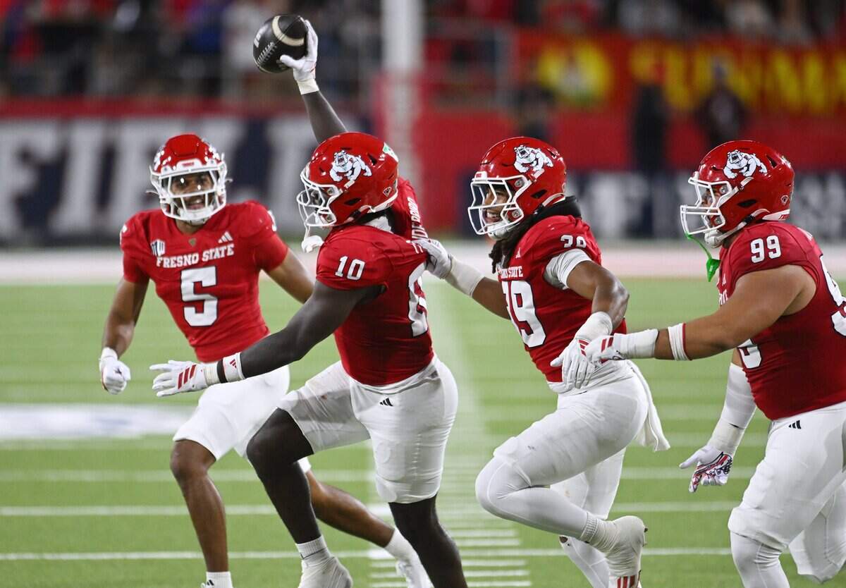 Fresno State's K'vion Thunderbird, center, celebrates recovering Nevada's tipped pass during the first half Saturday, Oct. 4, 2025 in Fresno.