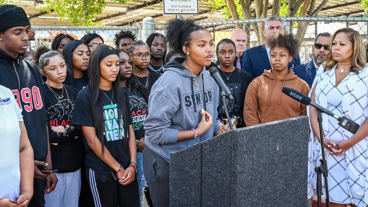Bullard High Black Student Union representative Elana Henderson addresses the media about additional racist images that have appeared over the weekend, during a news conference held by FUSD Trustee Keshia Thomas, right, outside Edison High School on Monday, May 9, 2022. Students walked out of classes on Friday when racist images emerged on social media.