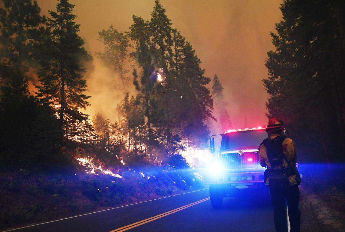 Flames burn along Highway 168 near Lakeview Drive Sunday, Sept. 6, 2020 in Shaver Lake.