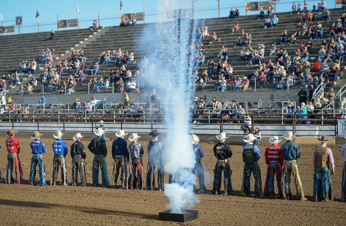 Bull riders are introduced with fireworks and fanfare before the start of PBR event on the first night of the Clovis Rodeo at the Clovis Rodeo Grounds on Wednesday, April 21, 2021. Fan capacity had been set at 40% but then recently raised to 67% after Fresno County entered the orange Tier.