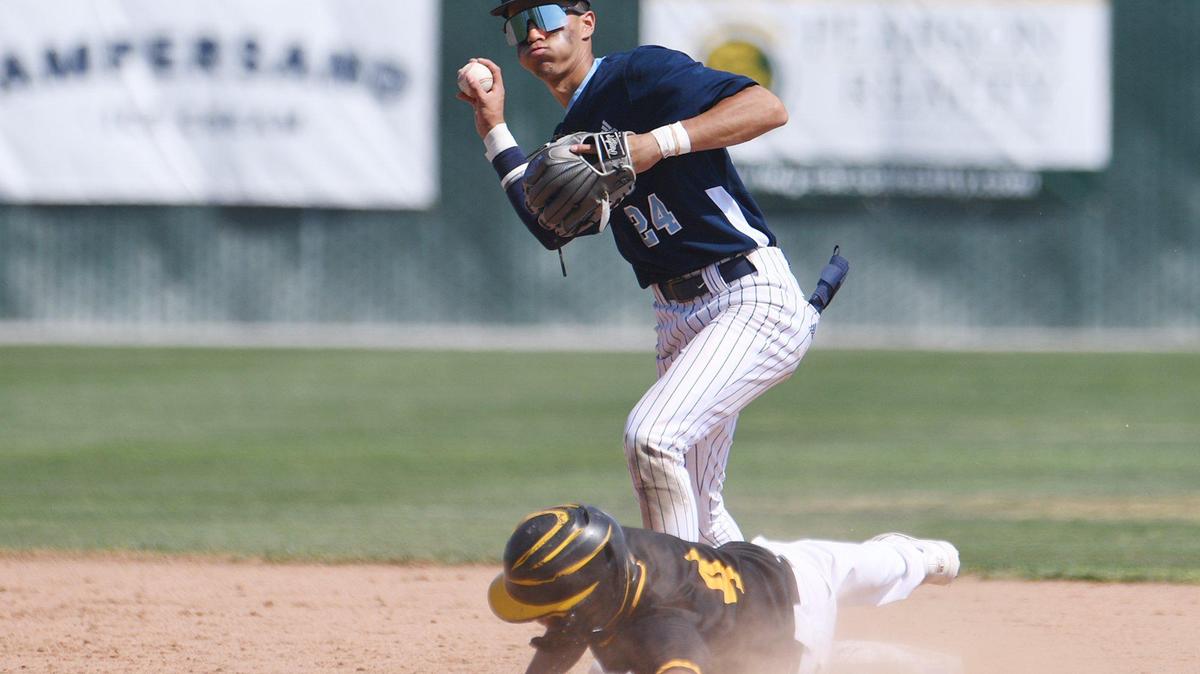 Bullard’s JayLn Utendahl, top, looks to throw to first base after Edison’s (#4), bottom is out at second in a County/Metro Athletic Conference baseball game Saturday, March 26, 2022 in Fresno.