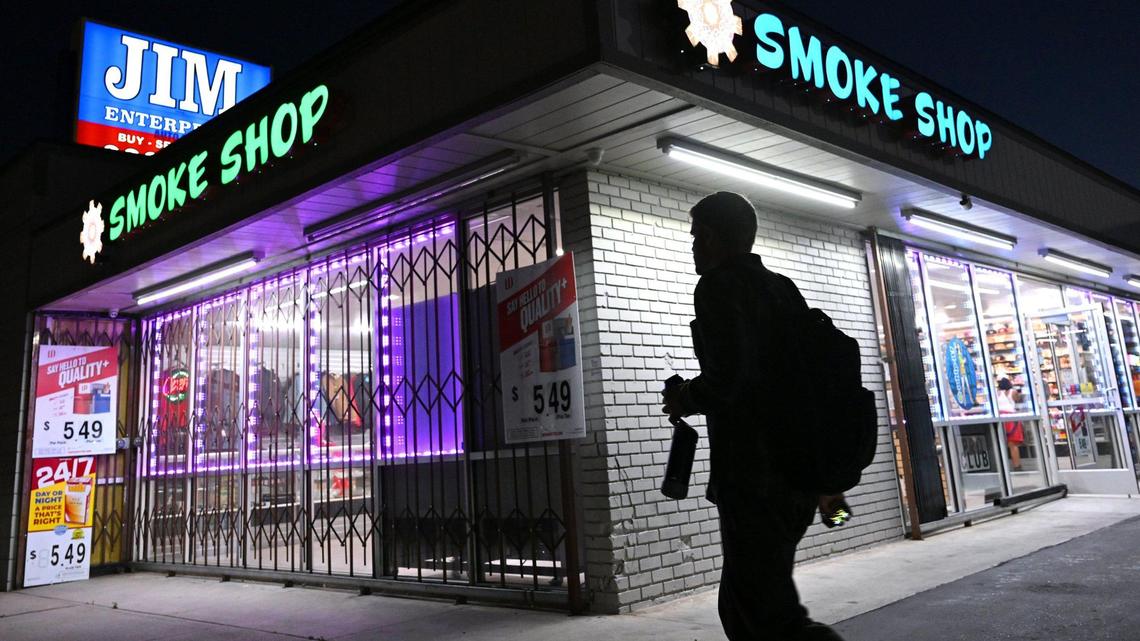 A pedestrian passes Kaleidoscope Smoke Shop along Blackstone Avenue on Thursday evening, May 6, 2025 in Fresno. A new ordinance passed by the Fresno City Council and approved by mayor Jerry Dyer will limit the number of smoke shops in the city.