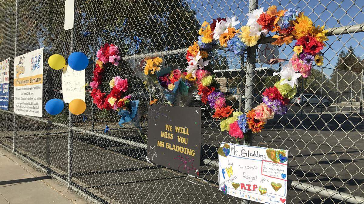 A memorial for Gavin Gladding takes shape on a fence at Fort Washington Elementary School on Monday morning, Sept. 17, 2018. Gladding, 43, a guidance instruction specialist at the school, was killed Sunday in a hit-and-run. He was out running about 6 a.m. alongside Friant Road.