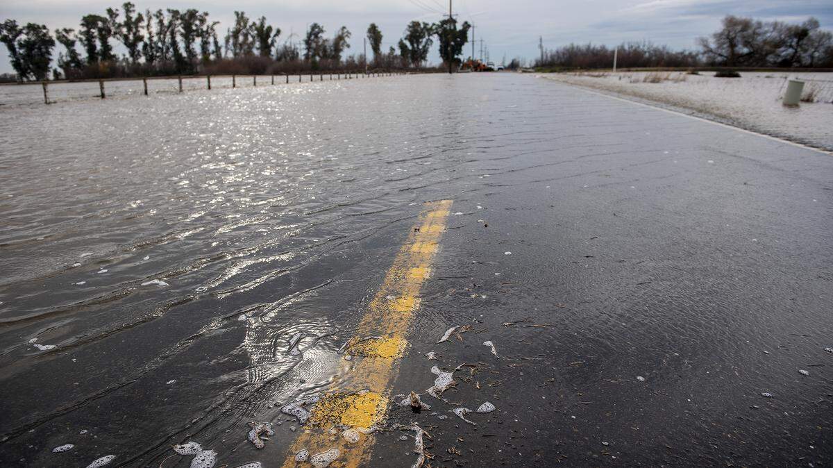 Floodwater flows over a section of Highway 59 just north of Mariposa Creek in Merced County, Calif., on Monday, Jan. 2, 2023.