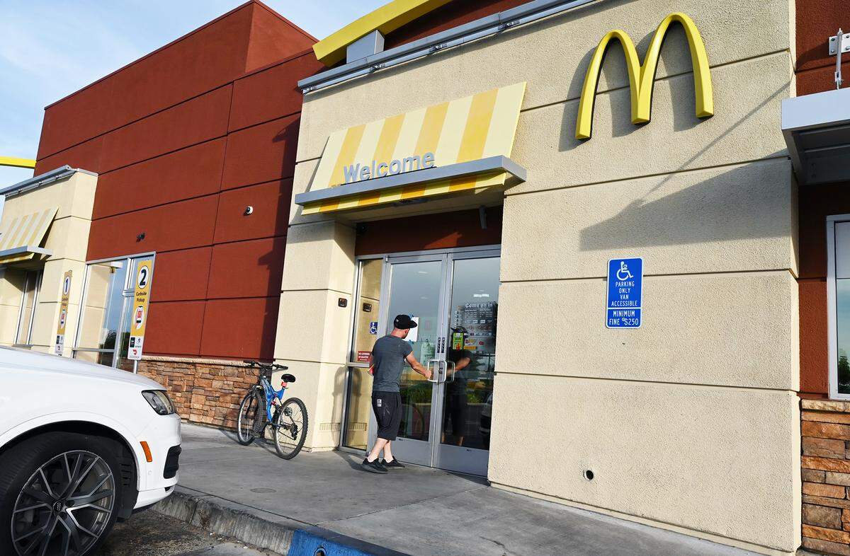 A man who arrived by bicycle discovers the McDonald’s on Academy Ave in Sanger is closed for maintenance, Friday, June 3, 2022. Video on social media has shown a mouse running freely near employees shoes inside the restaurant, as an employee is overheard suggesting an inspection took place earlier that day.