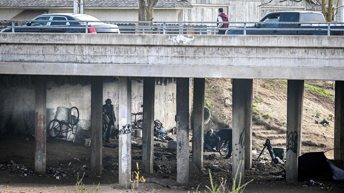 A homeless encampment appears below the Cleveland Avenue bridge at the Fresno River in Madera on Thursday, Dec. 19, 2024.