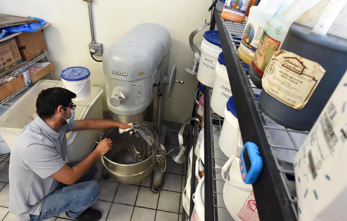 Andy Garcia cleans the mixer at his family’s Panderia Cafe Oaxaca on Feb. 15. Baking supplies have proven harder to acquire due to the pandemic.