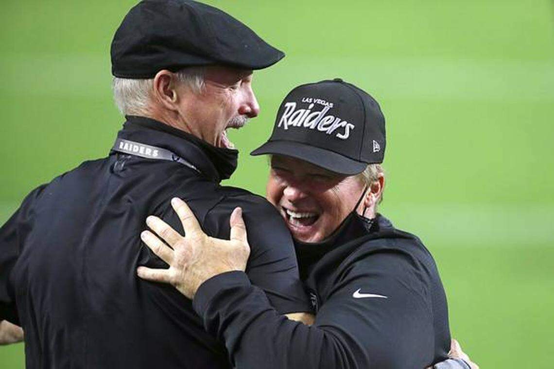 Las Vegas Raiders GM Mike Mayock, left, embraces head coach Jon Gruden after defeating the New Orleans Saints in an NFL football game, Monday, Sept. 21, 2020, in Las Vegas.