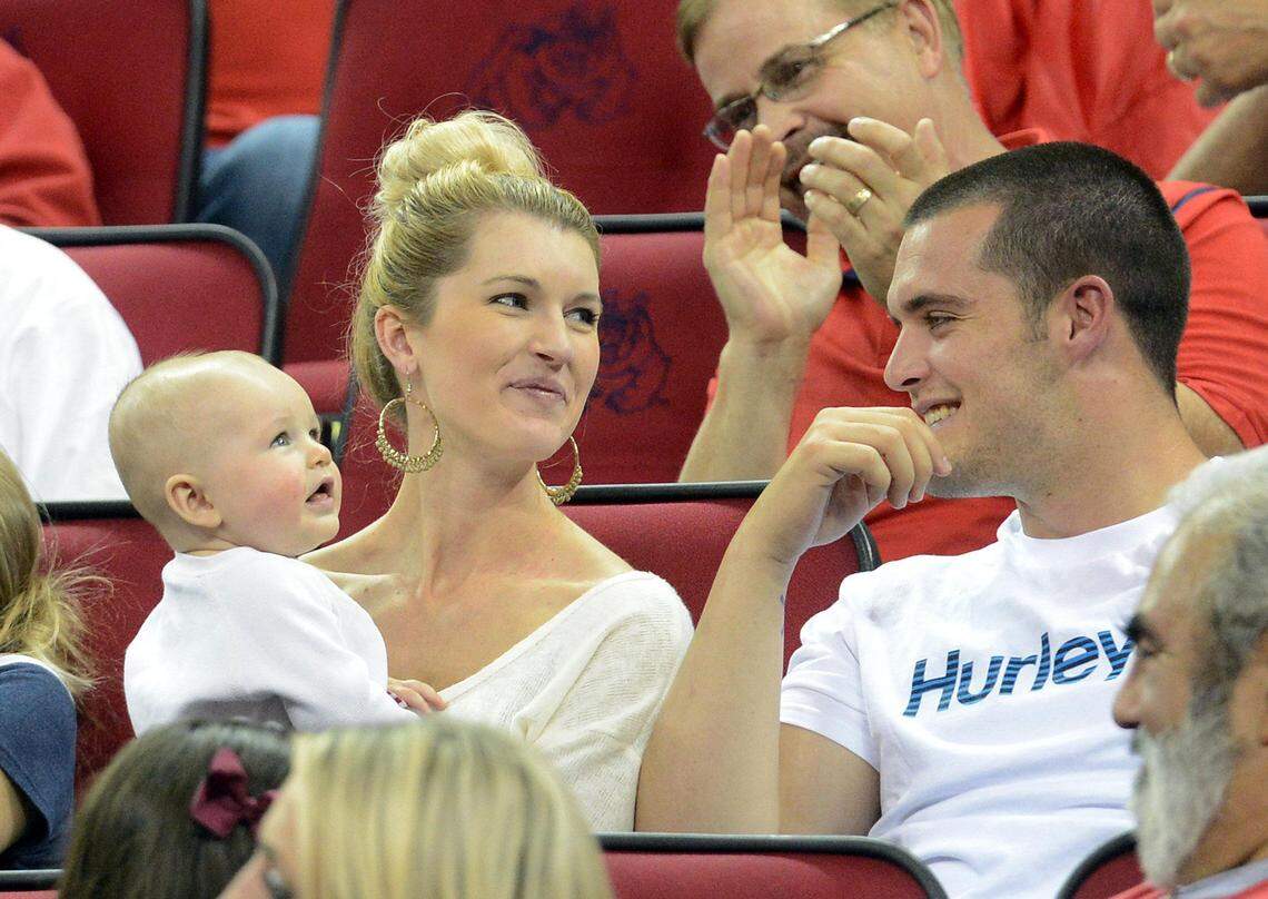 Derek Carr, left, wife Heather and son Dallas are seen in a 2014 file photo.