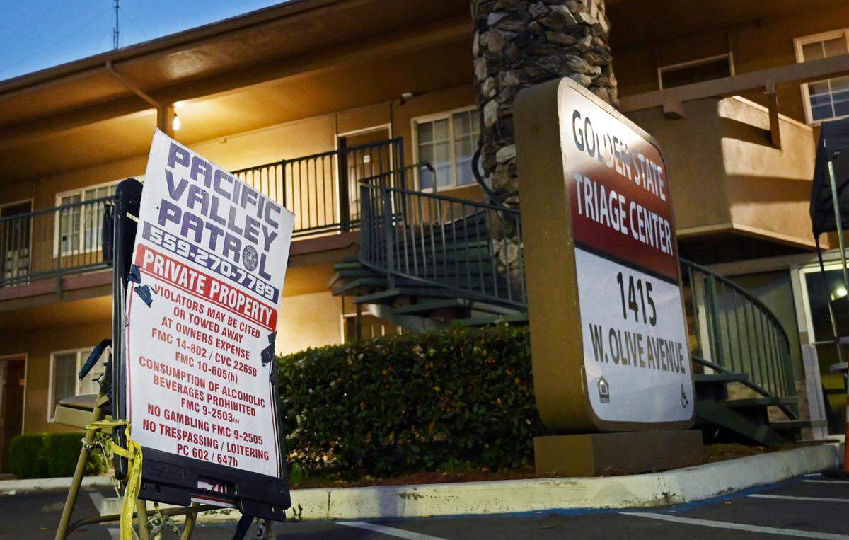 Pacific Valley Patrol security guards maintain a station outside the Golden State Triage Center, a former motel turned into housing for the homeless Tuesday, April 5, 2022 in Fresno.
