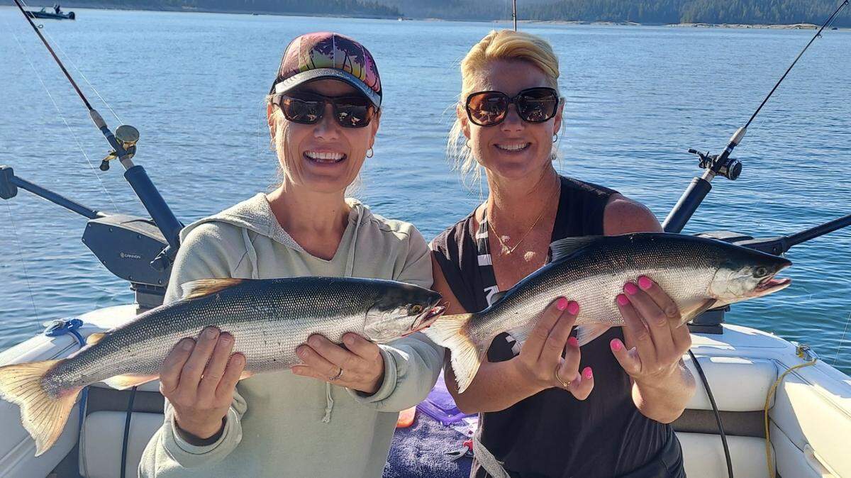 Cami Gioffre, left, and Terra Brusseau, both of Clovis, show off big kokanees caught fishing with Dick Nichols the week of July 11 at Shaver Lake. Gioffre’s fish measured 19.3 inches and Brusseau’s 18.7, Nichols said, and each was part of a mixed limit.