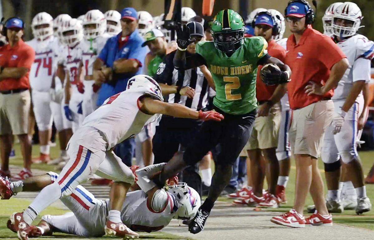 Roosevelt running back Ehis Idoni, right, is forced out of bounds by Firebaugh at Sunnyside's stadium Friday, Sept. 12, 2025 in Fresno. The Rough Riders pummeled the Eagles 46-6 with Firebaugh scoring their only touchdown in the final minutes of the game.