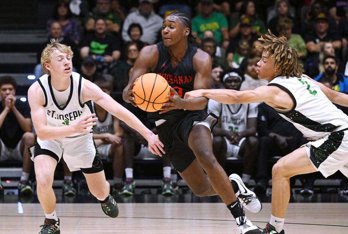 Buchanan’s Jaiden Anderson, center, is fouled in the CIF Division I Boys Basketball Championship against St. Joseph Saturday, March 1, 2025 in Fresno.