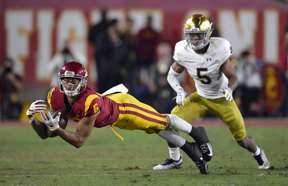 USC wide receiver Michael Pittman Jr., left, attempts to catch a pass while under pressure from Notre Dame cornerback Troy Pride Jr. during the Trojans’ 2018 finale at the Los Angeles Memorial Coliseum. Pittman is the son of the former Fresno State running back Michael Pittman.