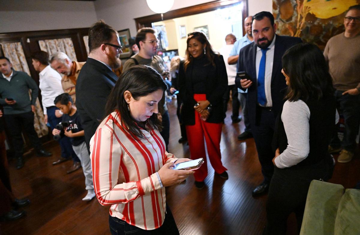 Fresno City Council District 5 candidate Elizabeth Jonasson Rojas, center, checks her phone for the first posted online results in the special runoff election Tuesday night, March 18, 2025 in Fresno.