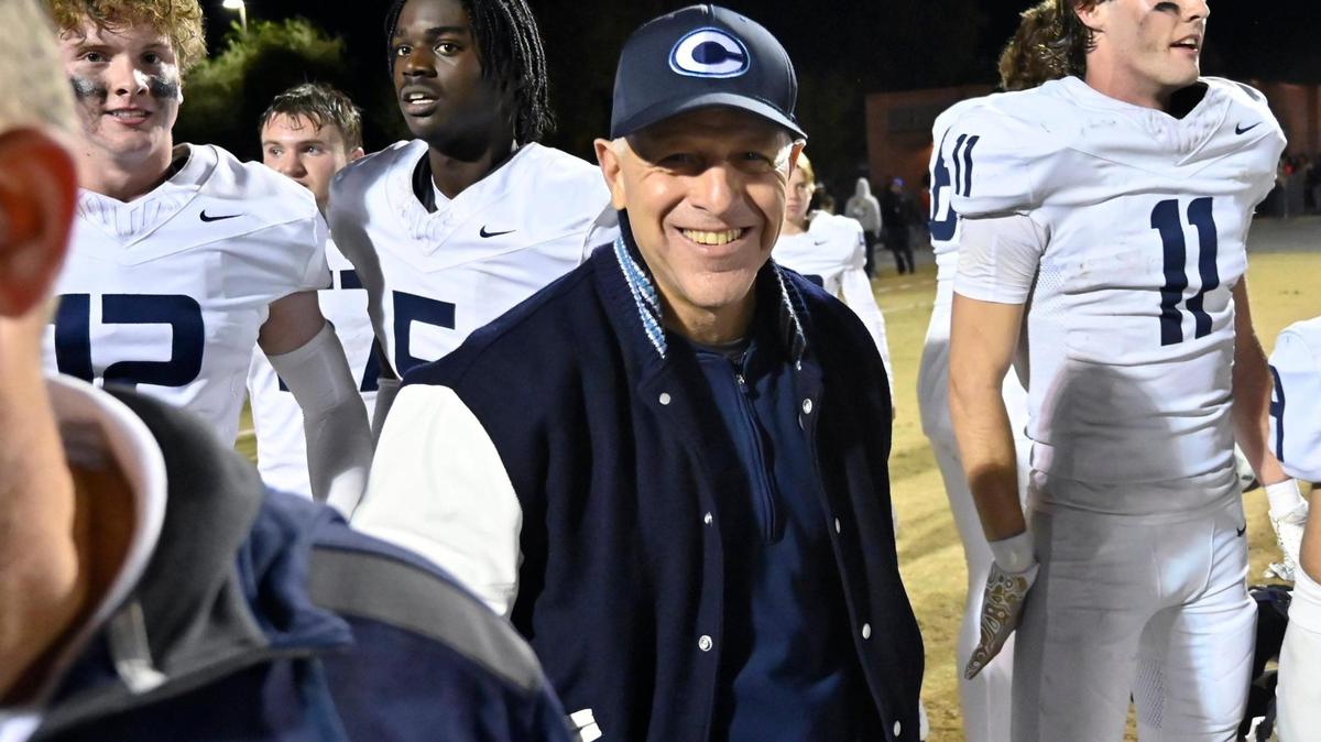 Central Valley Christian’s head coach Don Arax, center, smiles after the team’s 28-7 win over Golden West on Friday night, Nov. 22, 2024 in Visalia.