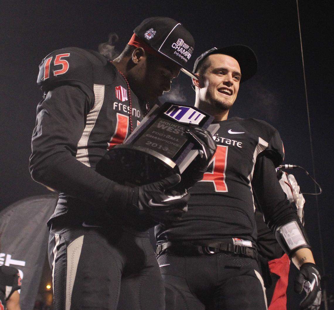 Davante Adams kisses the Mountain West trophy as Derek Carr looks on in the second half of a college football game in Fresno, Calif., Saturday, Dec. 7, 2013. The Las Vegas Raiders acquired Adams from the Green Bay Packers on Thursday, March 17, 2022.