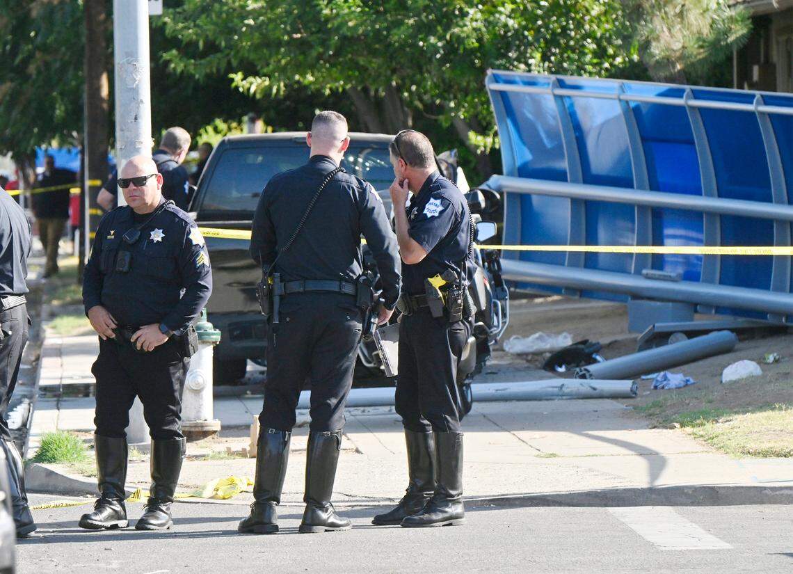Police officers gather at the site of a collision on Cedar Avenue across from Roosevelt High School on Wednesday, Sept. 6, 2023, in Fresno, California.