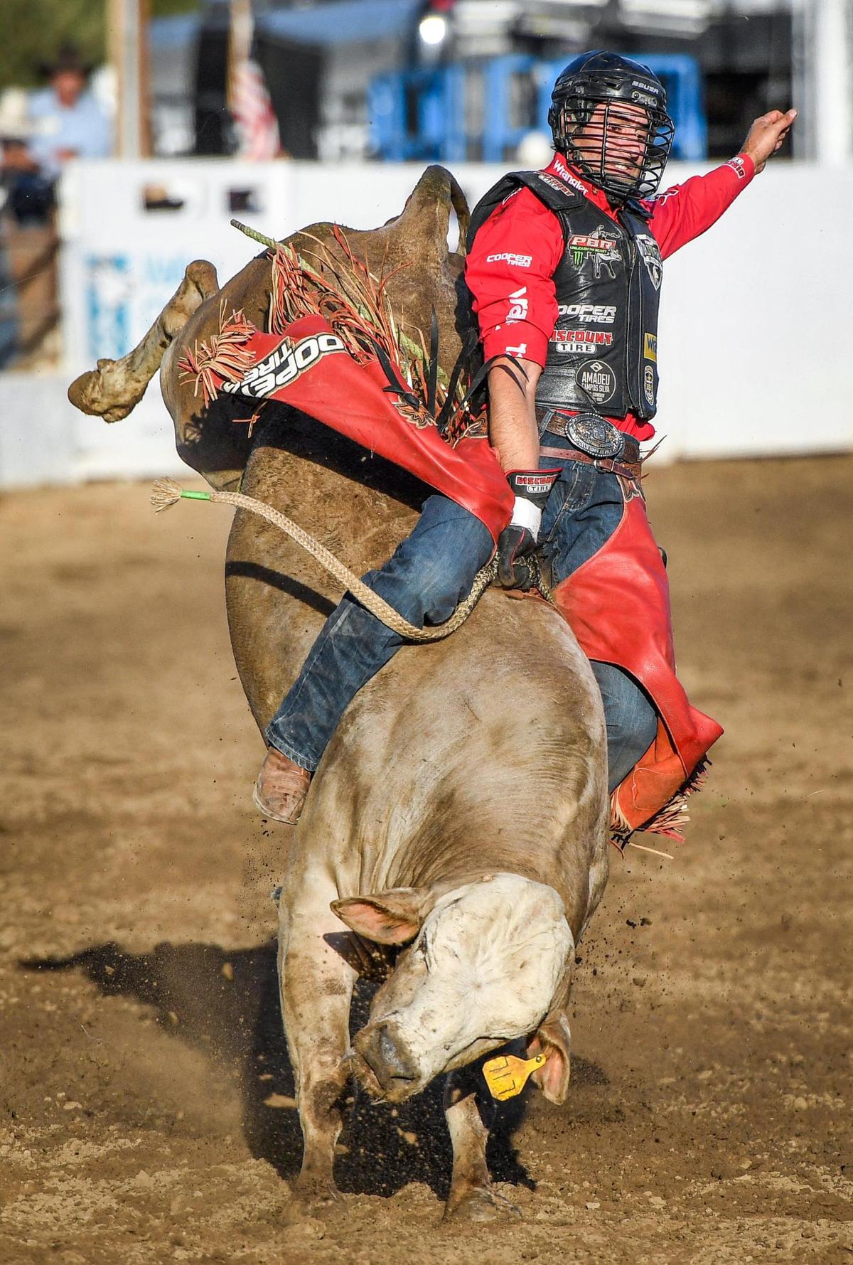 Silvano Alves rides Cake Pop in the first section of bull riding during the Professional Bull Riders event on the opening day of the Clovis Rodeo on Wednesday, April 20, 2022.