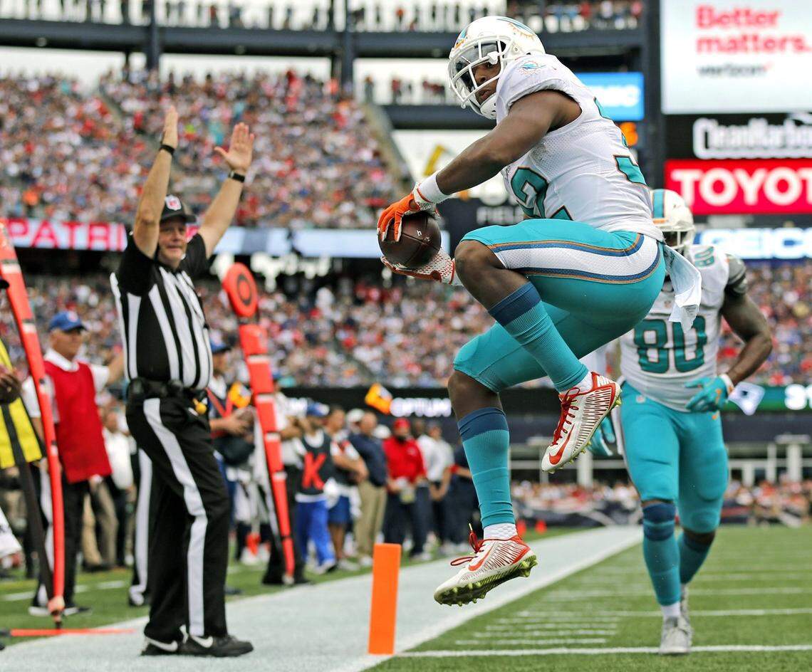 Kenyan Drake celebrates after scoring late in the fourth quarter for Miami as the New England Patriots host the Dolphins at Gillette Stadium on Sunday, September 18, 2016.