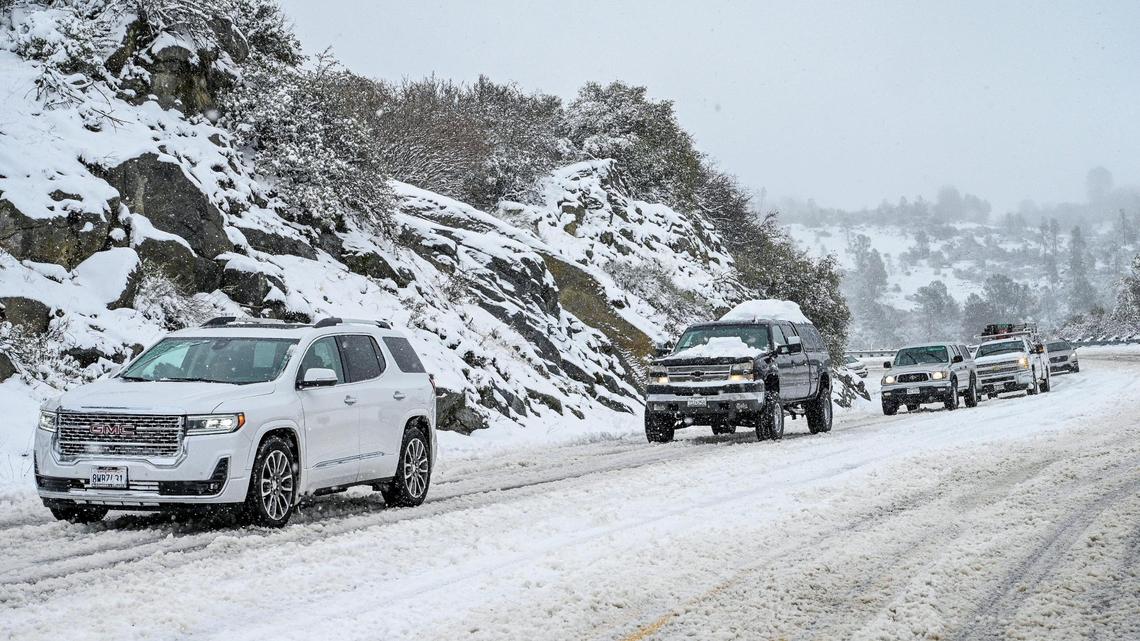 Vehicles slowly descend down the four lane section of Highway 168 west of Pine Ridge during a snowstorm on Monday, Dec. 27, 2021.